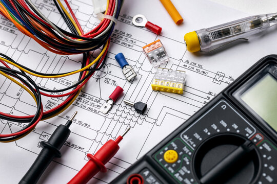 Professional electrical wiring schematic with multimeter and tools
