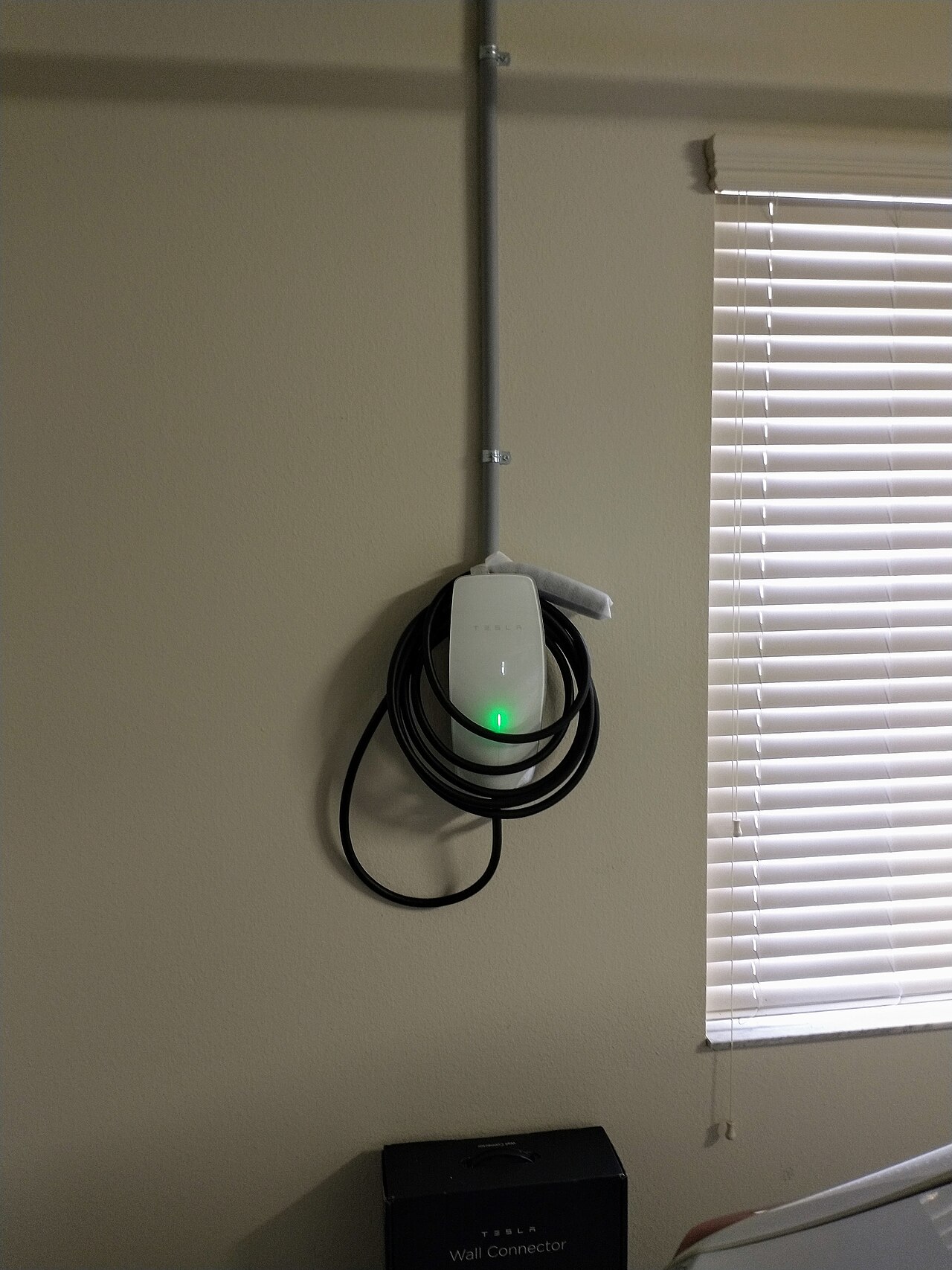 Tesla Wall Connector EV charger professionally mounted in a residential home